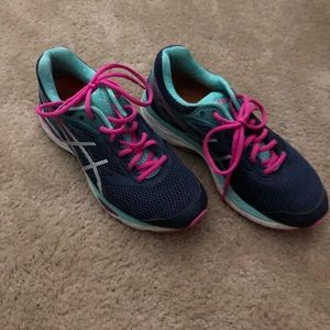 Navy and pink ASICS running shoes